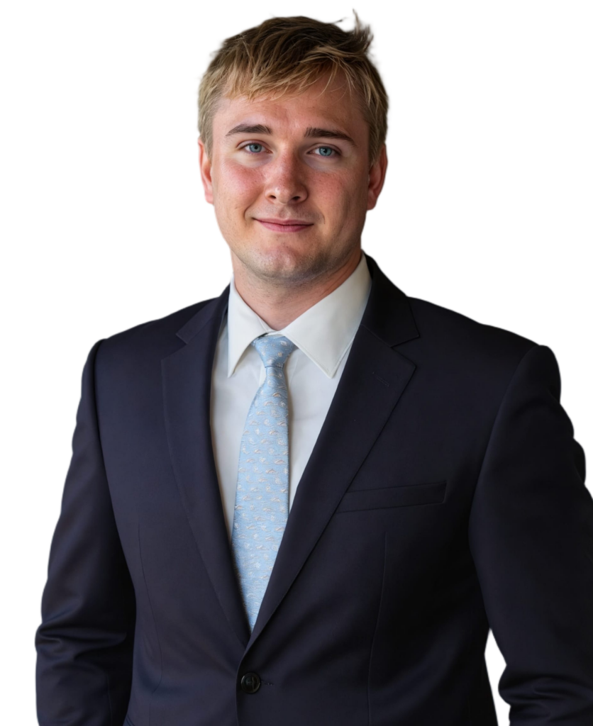 Niels Steinhof wearing a navy blazer and a light blue tie.